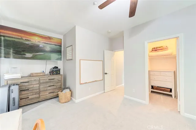 an empty room with cabinet and mirrors