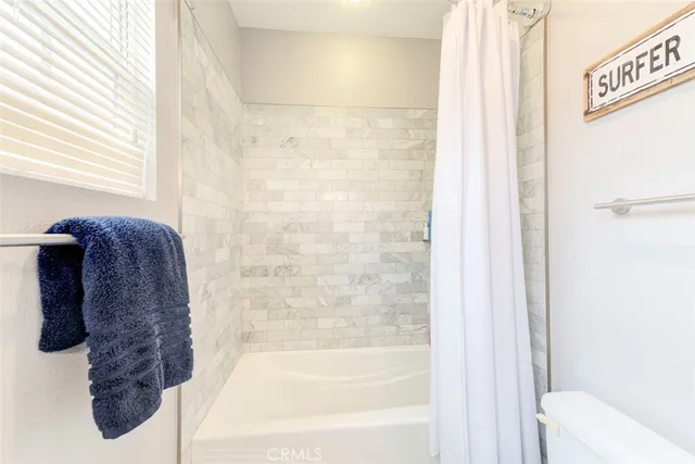 a bathroom with a bathtub and shower