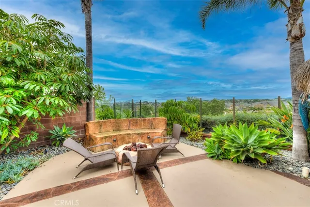 a view of a patio with couches table and chairs and potted plants