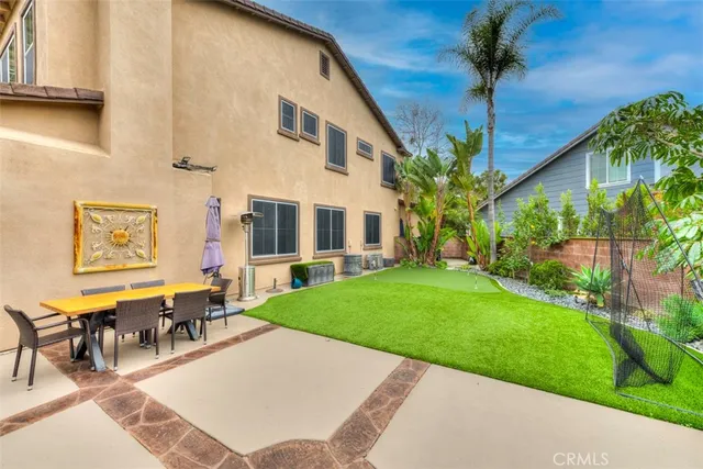 a view of a house with backyard porch and sitting area