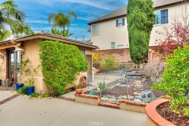 a backyard of a house with a garden and plants