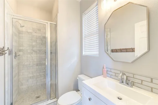 a bathroom with a sink mirror vanity and toilet