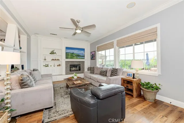a living room with furniture a fireplace and a large window