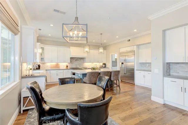 a large kitchen with a table and chairs