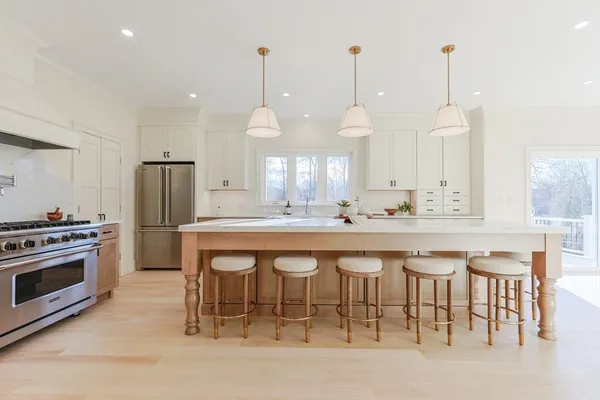 a large kitchen with a table and chairs