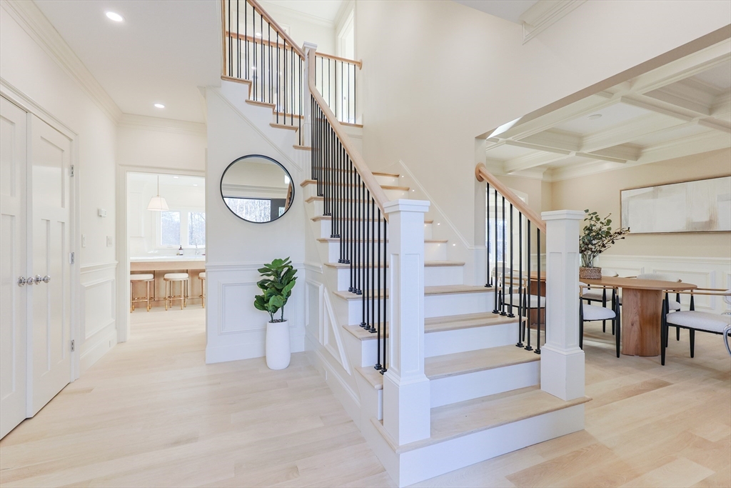 54 Woodland Road Scituate, MA 02066 - Photo 13 of 30 a view of entryway dining room and hall with wooden floor