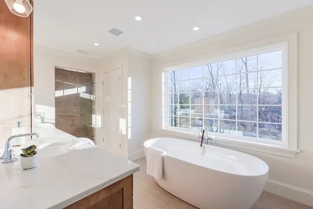 a bathroom with a granite countertop shower mirror and toilet