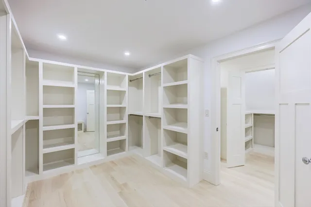 a bedroom with a large bed and a window