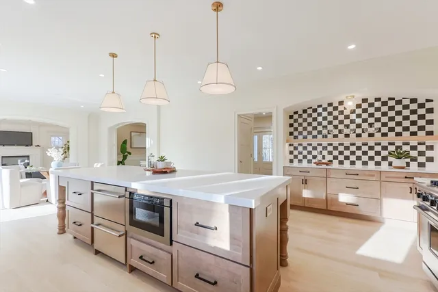 a kitchen with a sink window and cabinets