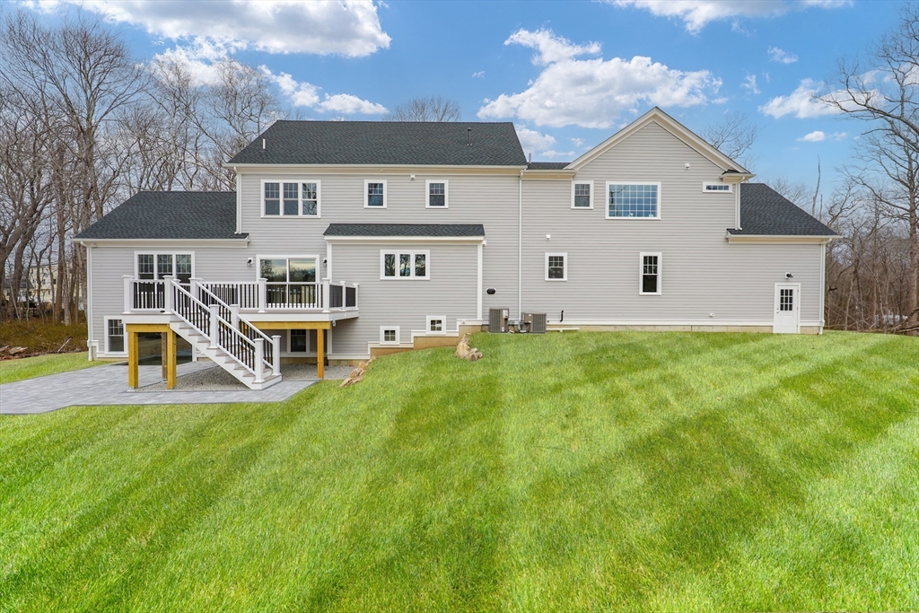54 Woodland Road Scituate, MA 02066 - Photo 28 of 30 a front view of house with yard and trees in the background