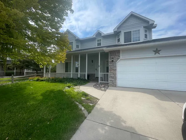 a front view of a house with a garden and yard