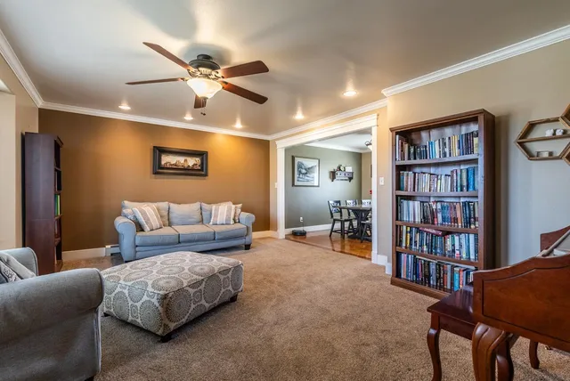 a living room with furniture and a bookshelf