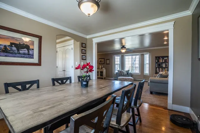 a dining room with furniture and wooden floor