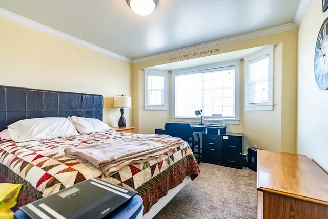 a bedroom with a bed and a table in it