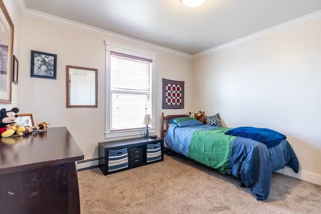 a bedroom with a bed and a desk