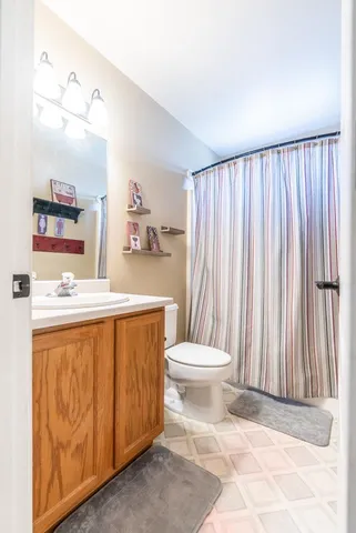 a bathroom with a toilet a sink and a mirror