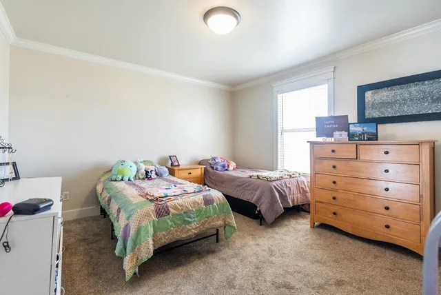 a bedroom with two beds and a couch