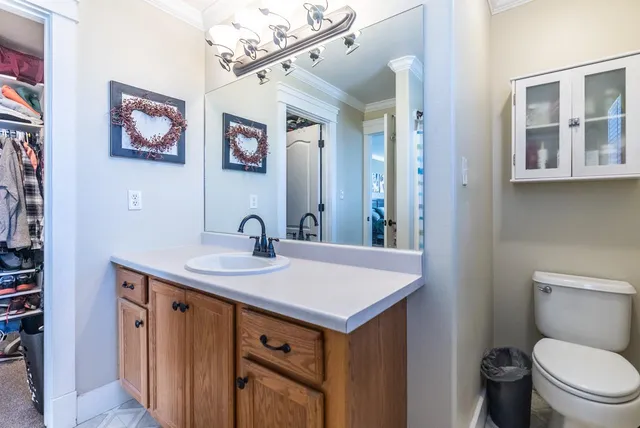 a bathroom with a toilet sink and mirror
