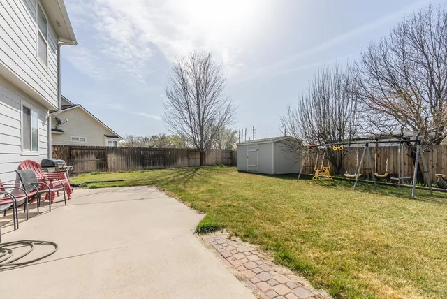 a backyard of a house with table and chairs