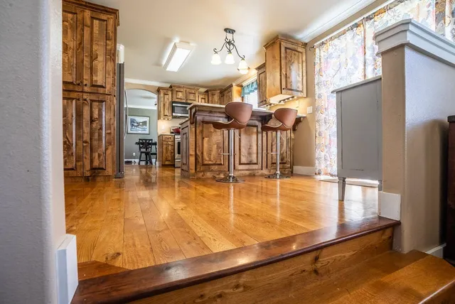 a indoor swimming pool with large windows and chairs