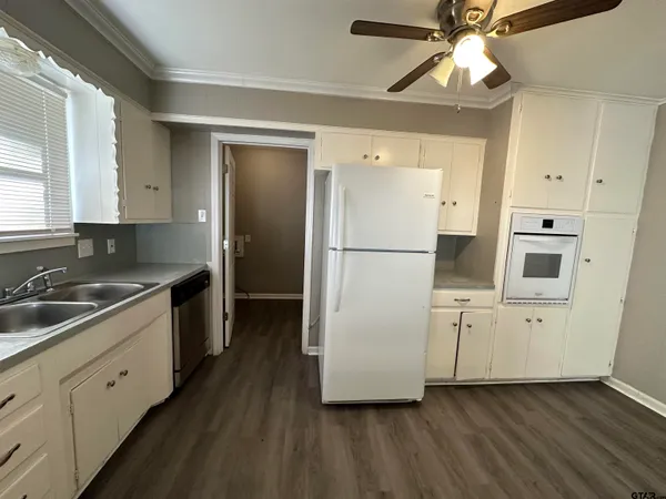 a kitchen with cabinets and stainless steel appliances