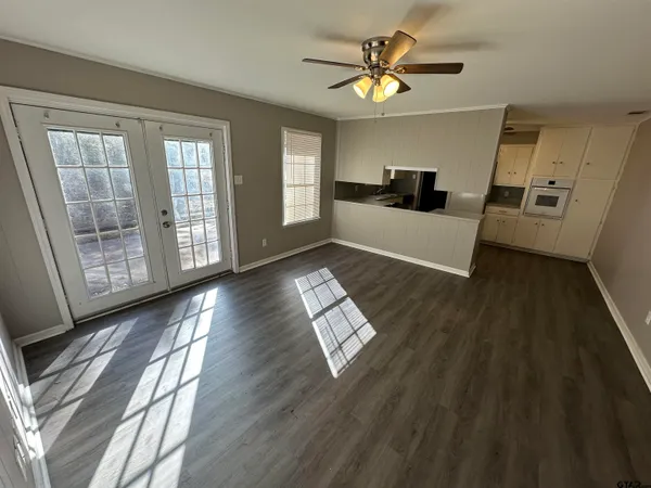 a living room with furniture and a wooden floor