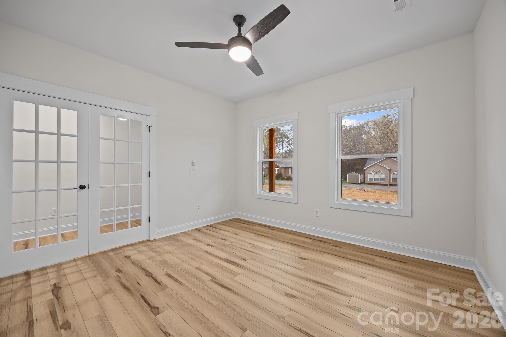 1030 Gibson Road Salisbury, NC 28147 - Photo 12 of 46 a view of empty room with windows and ceiling fan