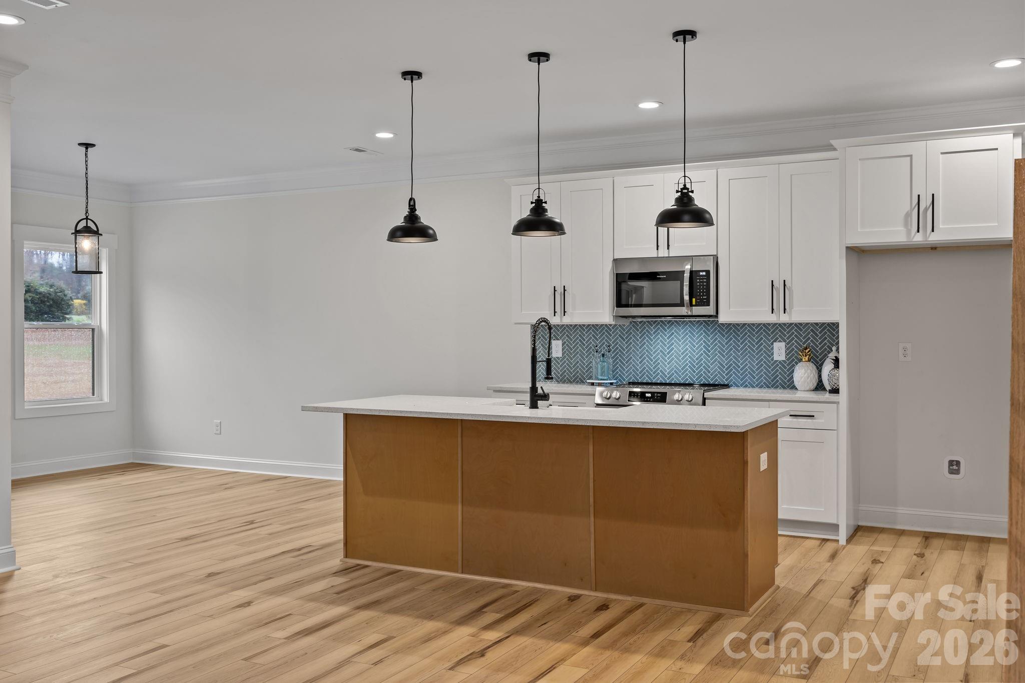 1030 Gibson Road Salisbury, NC 28147 - Photo 14 of 47 a kitchen with kitchen island a counter top space a sink and appliances