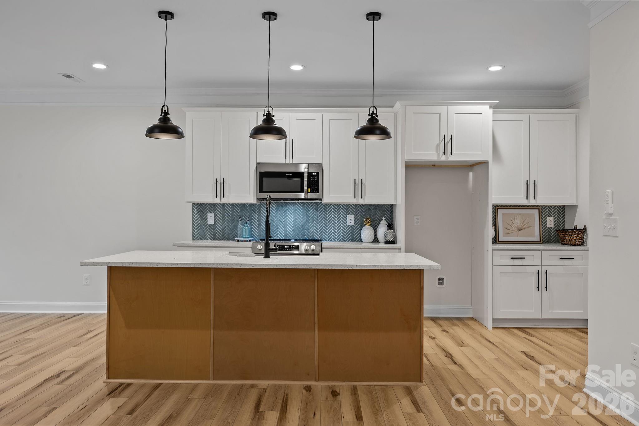 1030 Gibson Road Salisbury, NC 28147 - Photo 15 of 47 a kitchen with stainless steel appliances granite countertop a sink a stove and a refrigerator