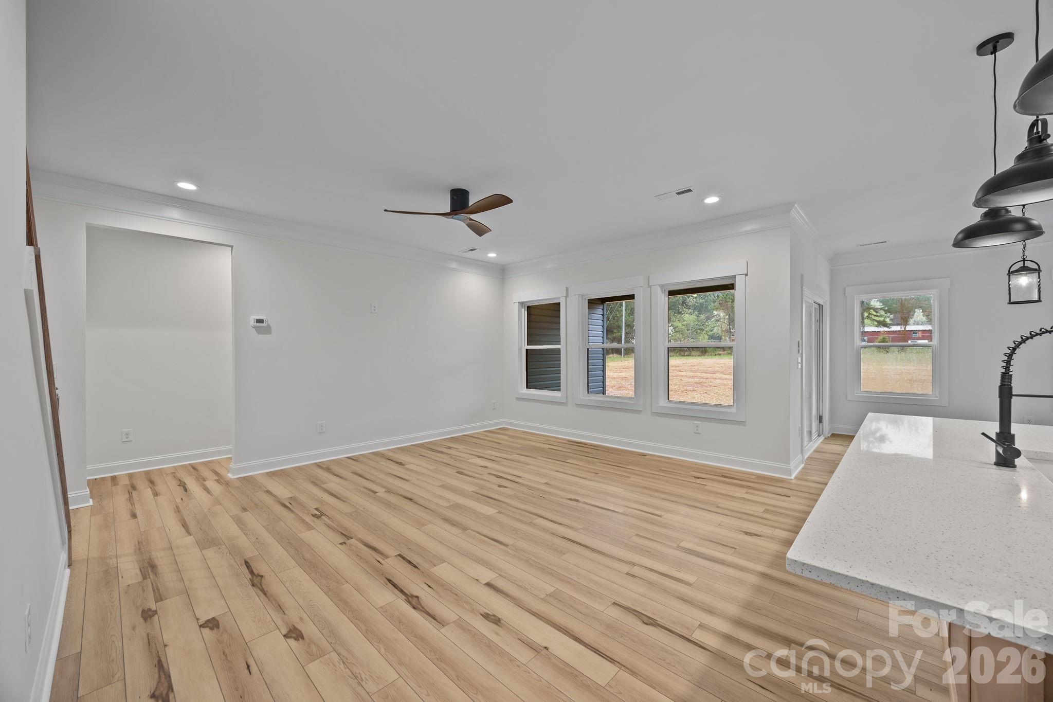 1030 Gibson Road Salisbury, NC 28147 - Photo 16 of 46 a view of empty room with wooden floor and fan