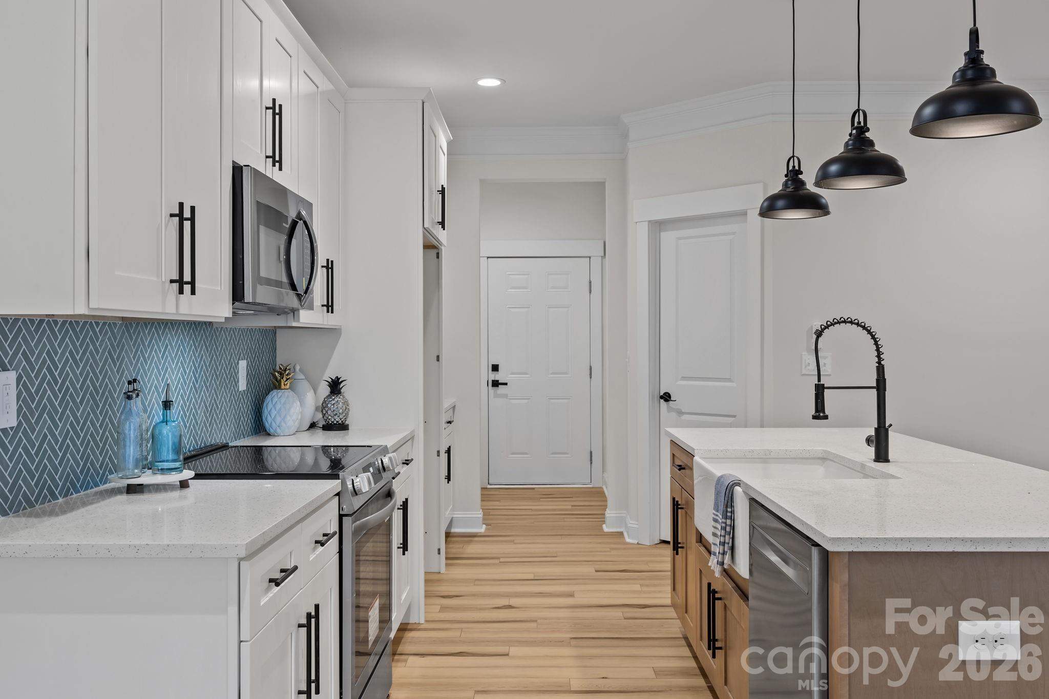 1030 Gibson Road Salisbury, NC 28147 - Photo 17 of 47 a kitchen with stainless steel appliances granite countertop a sink a stove and a refrigerator