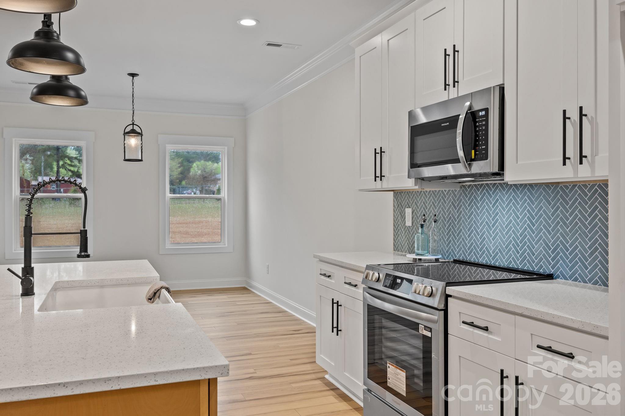 1030 Gibson Road Salisbury, NC 28147 - Photo 20 of 47 a kitchen with stainless steel appliances granite countertop a sink stove and microwave