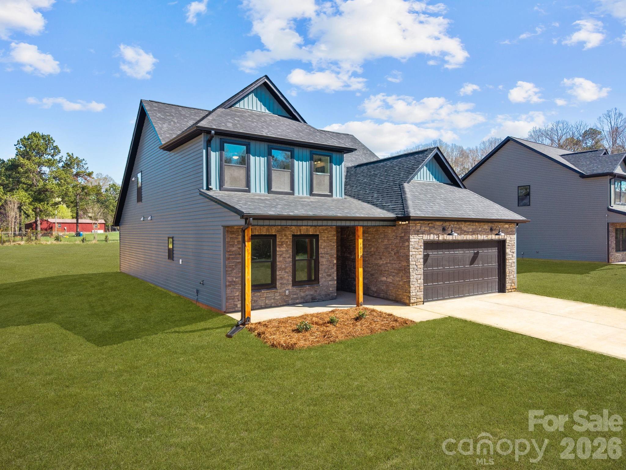 1030 Gibson Road Salisbury, NC 28147 - Photo 2 of 47 a front view of a house with a yard and garage