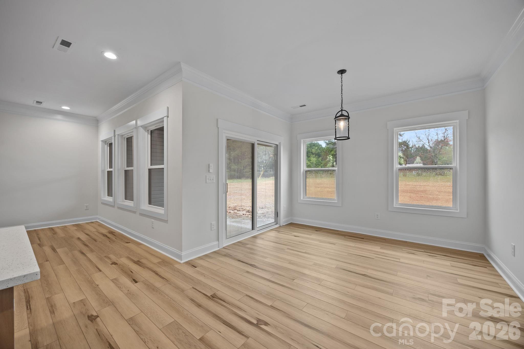 1030 Gibson Road Salisbury, NC 28147 - Photo 22 of 47 a view of an empty room with wooden floor and a window