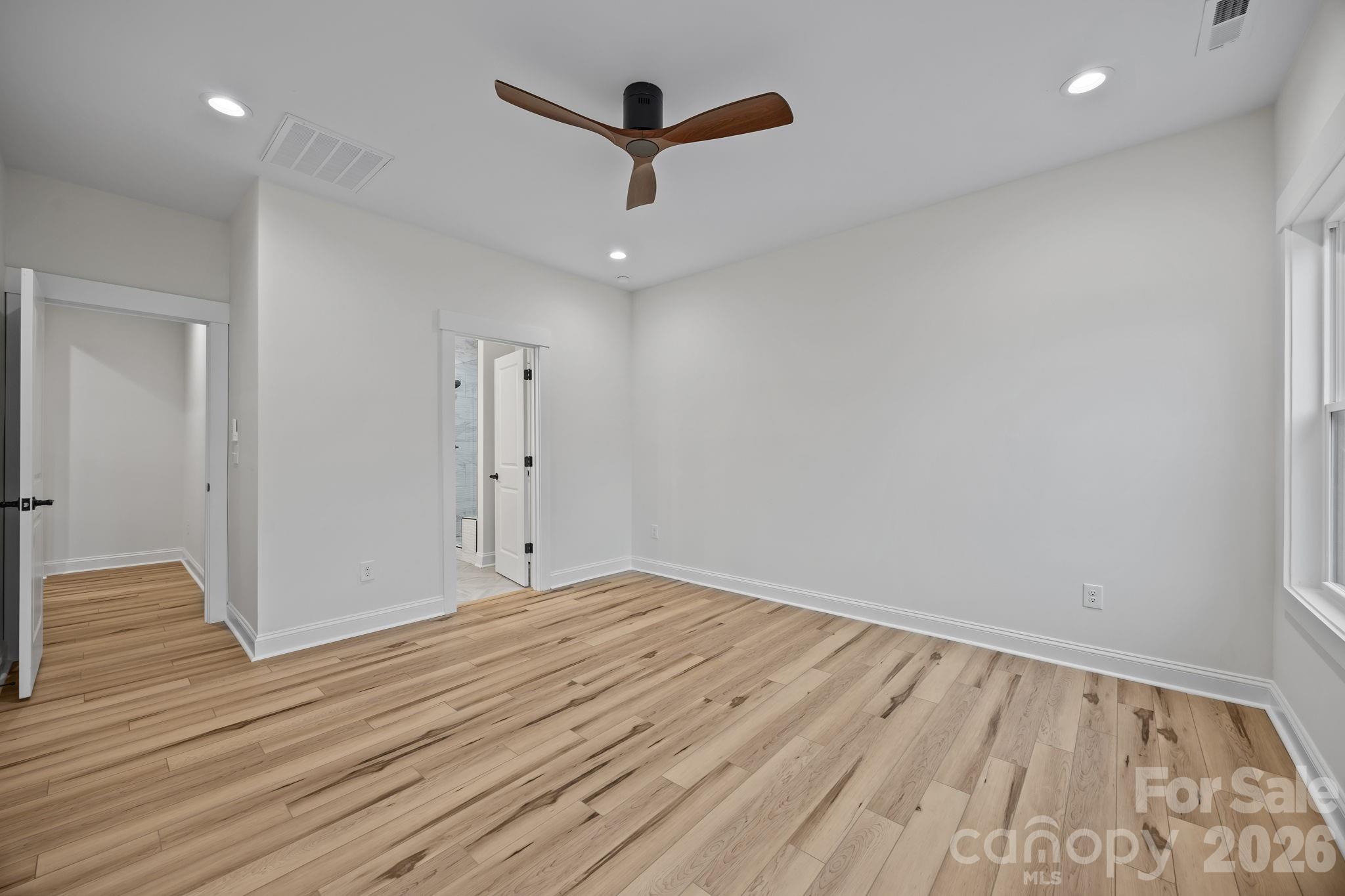 1030 Gibson Road Salisbury, NC 28147 - Photo 28 of 46 an empty room with wooden floor and a ceiling fan