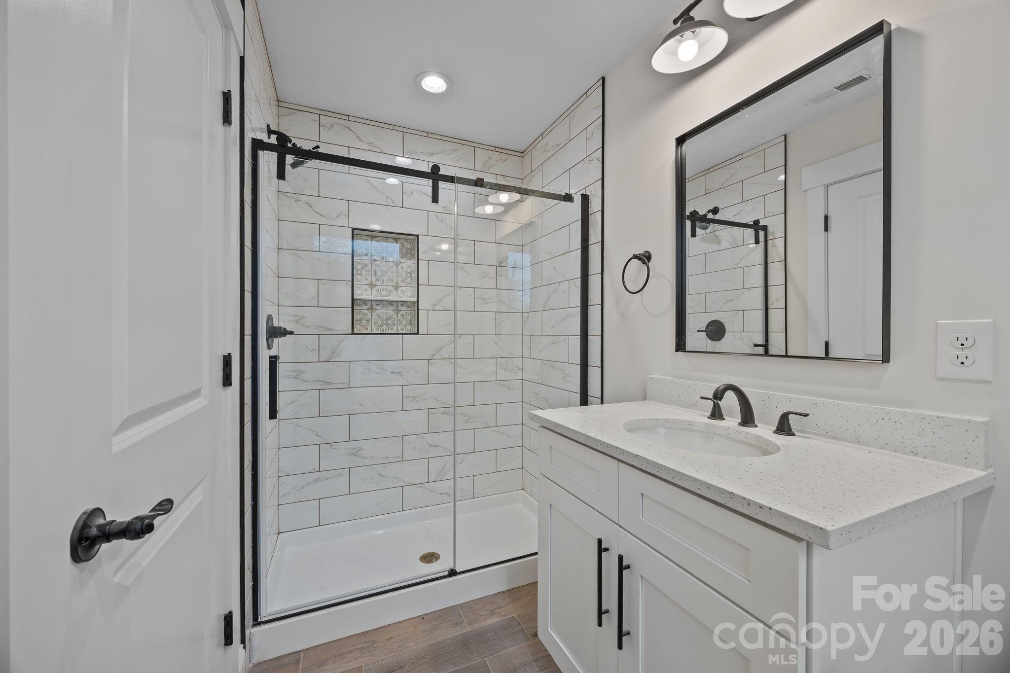1030 Gibson Road Salisbury, NC 28147 - Photo 42 of 47 a bathroom with a shower sink and mirror
