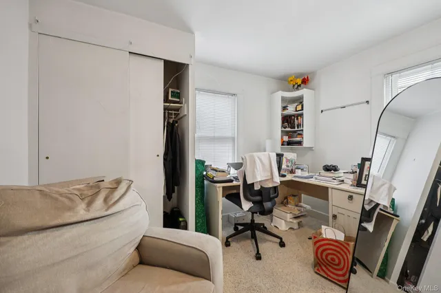 a bathroom with a granite countertop sink mirror vanity and toilet