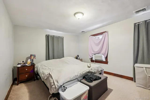 a bedroom with a bed and dresser