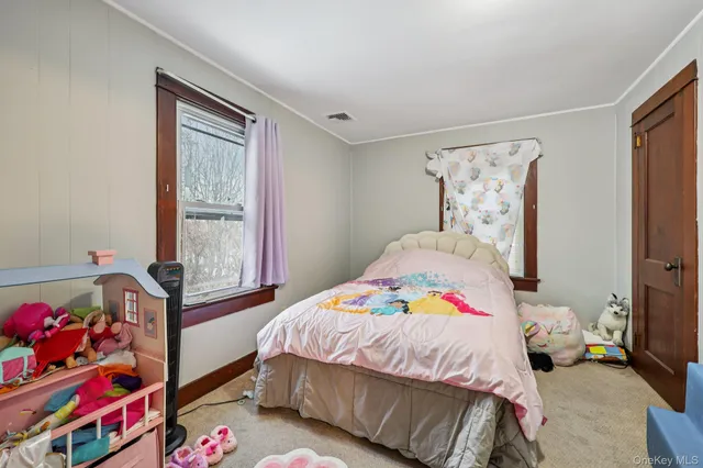 a bedroom with a large bed and a tv