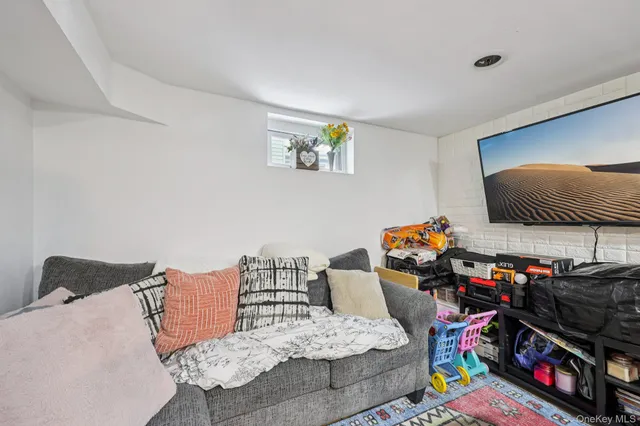 a front view of a house with a yard covered in snow