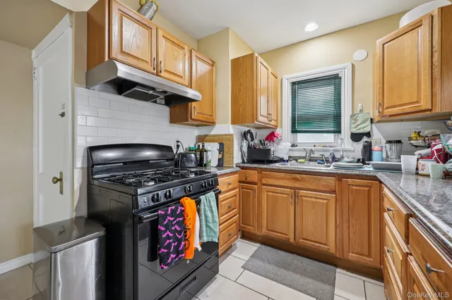 a kitchen with stainless steel appliances granite countertop a stove sink and cabinets