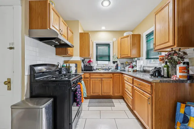 a kitchen with stainless steel appliances granite countertop a stove a sink and a refrigerator