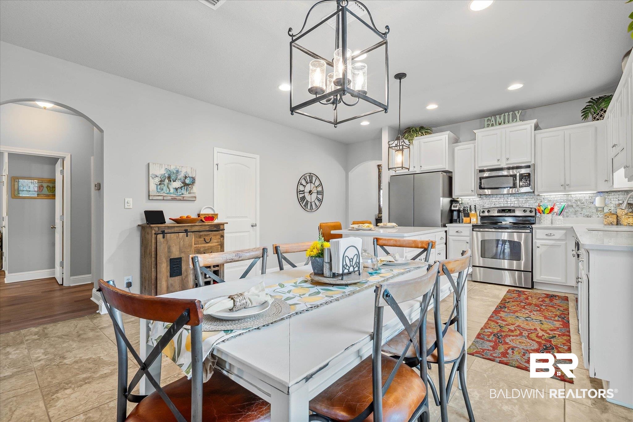10677 Orkney Way Spanish Fort, AL 36527 - Photo 8 of 22 Dining space featuring arched walkways, recessed lighting, light tile patterned floors, and a chandelier