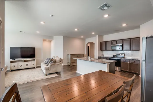 a kitchen with a stove a sink and a refrigerator