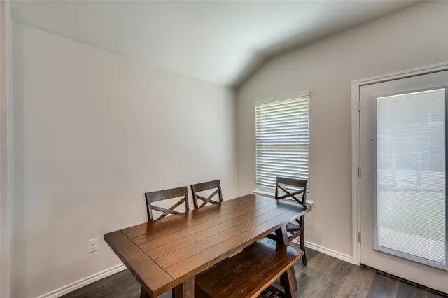 a living room with stainless steel appliances furniture and a flat screen tv