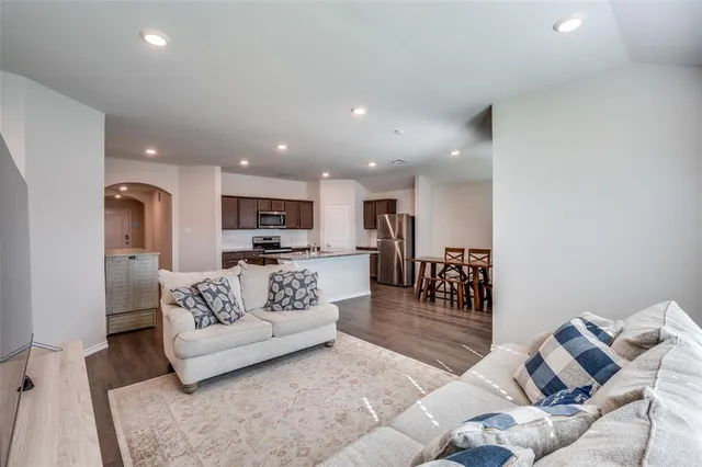 a living room with furniture and kitchen view