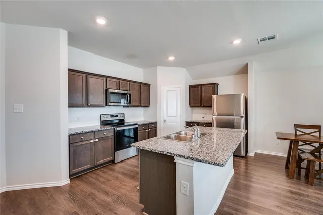a view of a kitchen with sink and microwave
