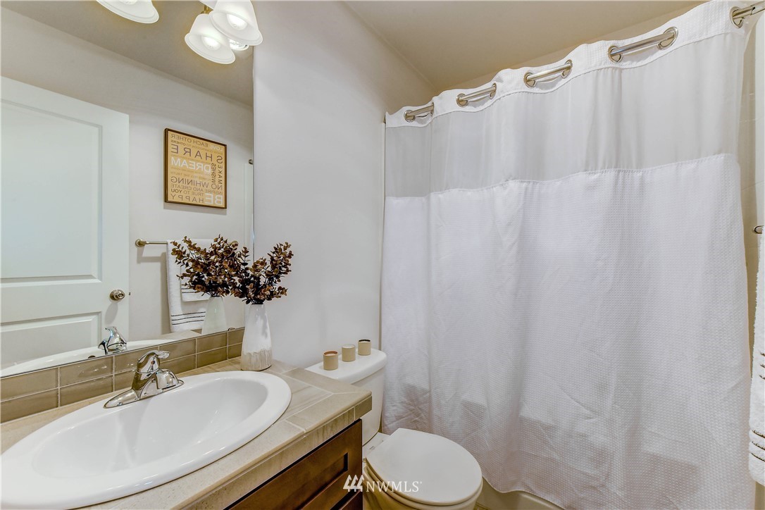 3010 34th Place Everett, WA 98201 - Photo 16 of 39 a bathroom with a sink vanity mirror and toilet