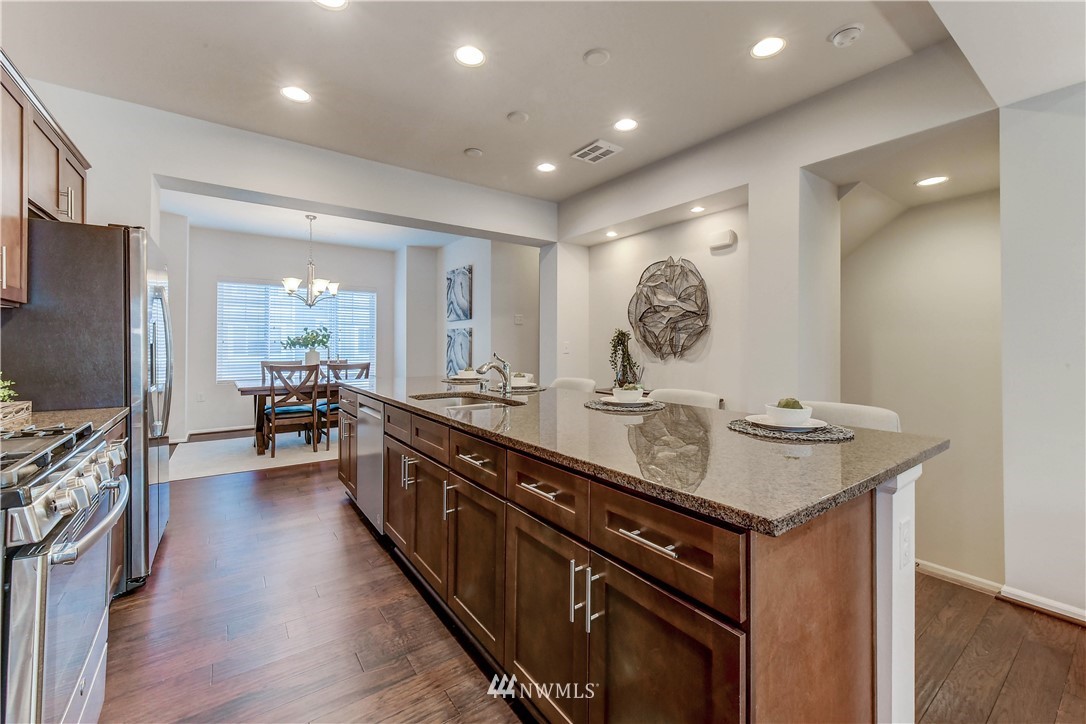 3010 34th Place Everett, WA 98201 - Photo 6 of 39 a kitchen with kitchen island granite countertop a sink appliances and cabinets