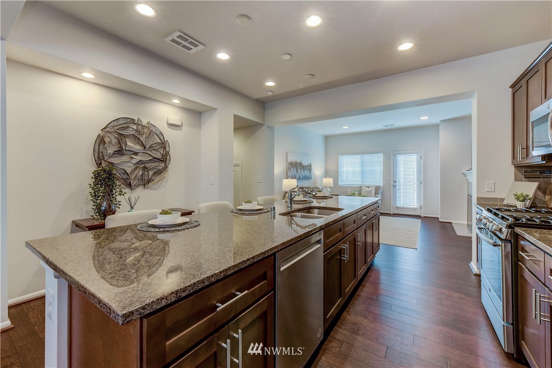 3010 34th Place Everett, WA 98201 - Photo 7 of 39 a large kitchen with stainless steel appliances granite countertop a lot of counter space and wooden floor